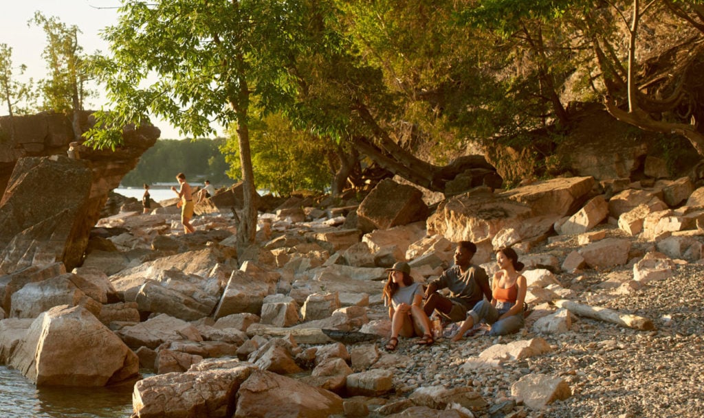 Image of a rocky beach with people enjoying the view